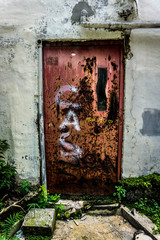 an abandoned old and grunge door with red colour photo taken in Jakarta Indonesia
