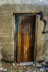 unmanaged and rusty old vintage door made from steel photo taken in Jakarta Indonesia