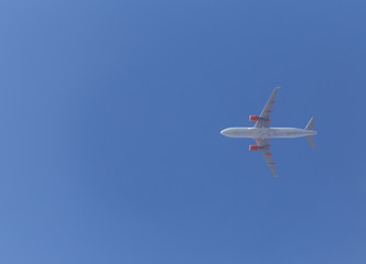 aircraft Airbus A320 flying in a blue sky