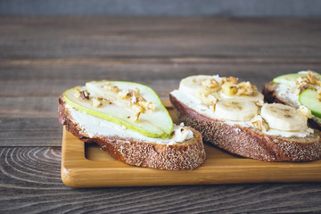 Sweet sandwiches  rye bread  ripe fruit pear banana Apple , healthy Breakfast