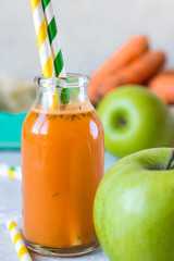 Detox of apples and carrots in a glass bottle