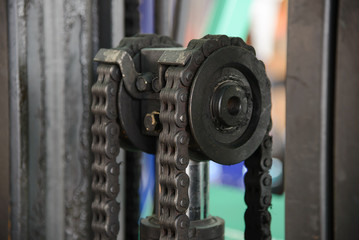 Close up of machine engine chain with cog wheel part of forklift truck