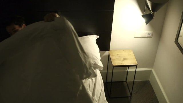 Person Lays Down In Bed Preparing To Go To Sleep Man Turns Off The Light And Prepares To Go To Sleep Person Going To Bed