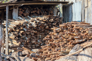 Abstract background of stored pieces of small wood ready for heating, chopped at home in the countryside.