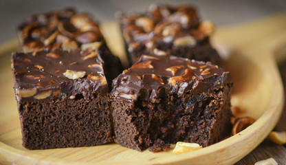 Fresh Homemade Chocolate Brownie with Almonds on the pallet wood.
