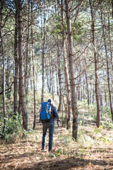 Fototapeta premium Rear of a young man with backpack goes on up to the mountain.