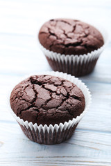 Chocolate muffins on a white wooden table