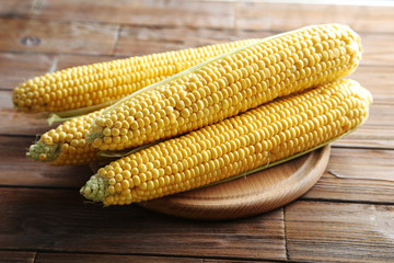 Sweet corns on a brown wooden table