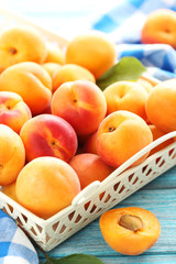 Ripe apricots fruit on blue wooden table