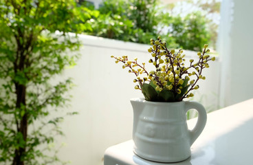 Yellow flowers in a white pot in the morning.