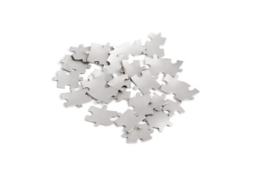 Metal puzzle pieces isolated on white