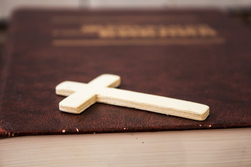 christian cross and bivle on wooden background