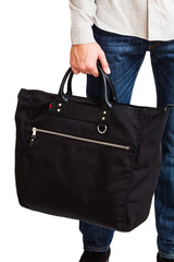 A man in a classic suit holds a black briefcase