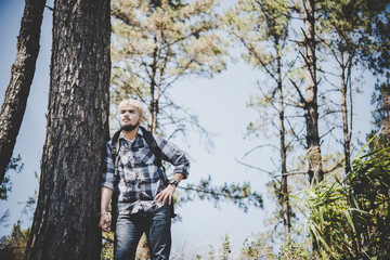 Young Man Traveler with backpack to mountain, Enjoying with nature around,Travel Lifestyle concept.