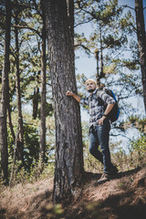 Obraz premium Young Man Traveler with backpack to mountain, Enjoying with nature around,Travel Lifestyle concept.