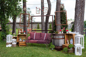 Beautiful wedding ceremony outdoors. Decorated chairs stand on the grass. Wedding arch made ...