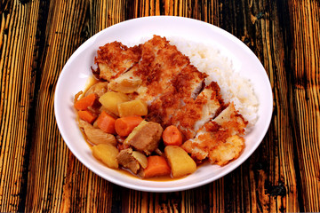 Rice with deep fried dolly fish in japanese yellow curry.