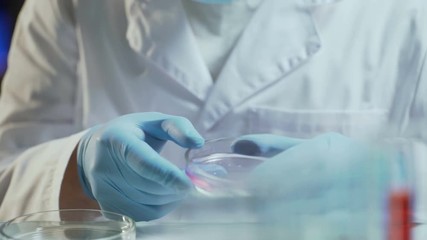 Laboratory worker conducting research testing consistency of biological material