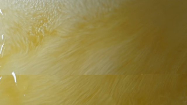 Closeup of beer glass in slow motion