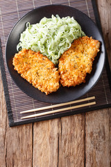 Japanese chicken cutlets in breadcrumbs Panko and noodles with green tea Macha. vertical top view