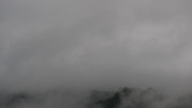 Time - lapse The fog is moving through the big Buddha on top of the mountain.
