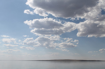 Fototapeta na wymiar the sky reflected in the water, deserted beach lake, summer sky, nature, blue cloud,