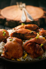 Chicken pieces baked in tomato sauce and boiled rice.