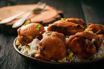 Chicken pieces baked in tomato sauce and boiled rice.
