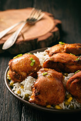 Chicken pieces baked in tomato sauce and boiled rice.