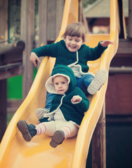 Fototapeta na wymiar happy children on slide at playground