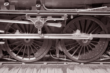 Fototapeta na wymiar Steam Train Wheels in Black and White Sepia Tone