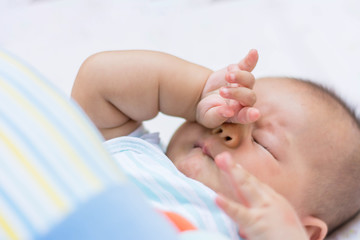 Baby rubbing it's eyes,