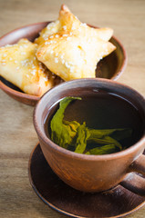 Green tea and pies on rustic wooden table