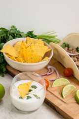 Delicious nachos with cheese on the white wooden background. Shallow depth of field.