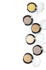 Obraz na płótnie Canvas Assorted eye shadow make up compacts arranged to form a page border, and isolated on a white background