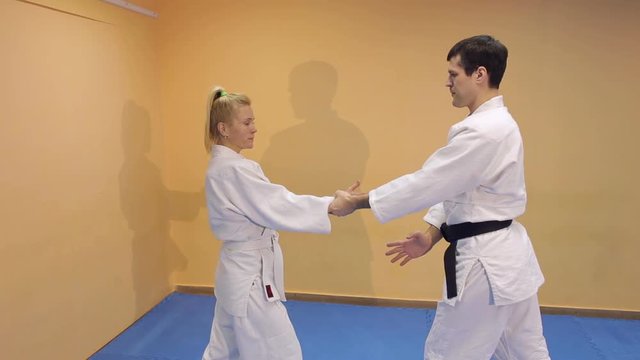 Man and woman doing Aikido in the martial arts school.