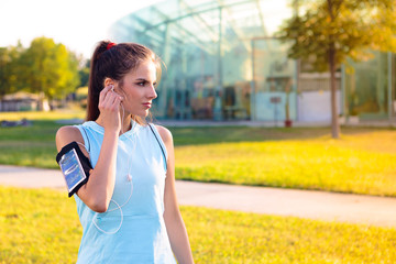 Sporty Woman listening to music with earphones