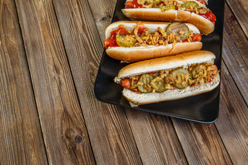 American hot dog with pickles,onions, ketchup and mustard