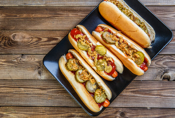American hot dog with pickles,onions, ketchup and mustard