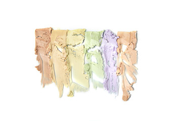 Smears of color correcting cream make up isolated on a white background