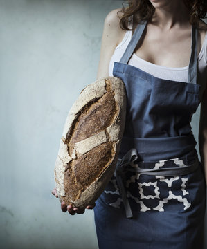 Woman holding a loaf of bread