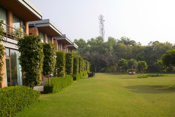 Grass lawn in front of a row of villas at a resort on the outskirts of Gurgaon, Haryana (India)
