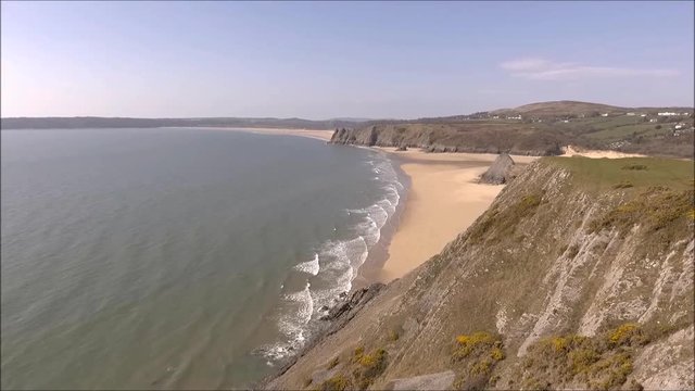 Spectacular Three Cliffs Bay on the Gower peninsula, also showing Pobbles Bay, The Great Tor and Oxwich Bay in Swansea, South Wales.
