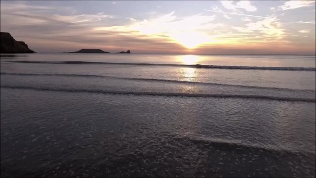 Worms Head at sunset at Rhossili beach on the Gower peninsula, Swansea, UK