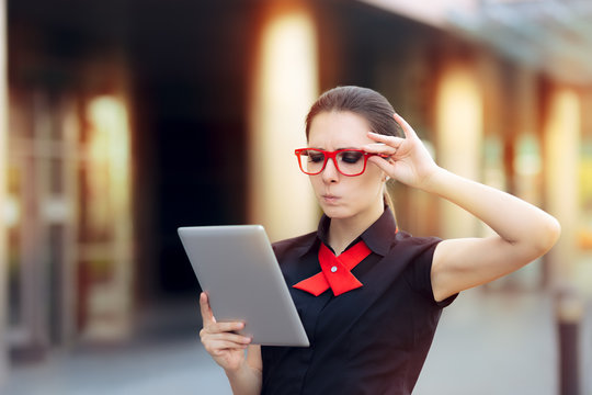 Discontent Businesswoman with Pc Tablet and Red Glasses