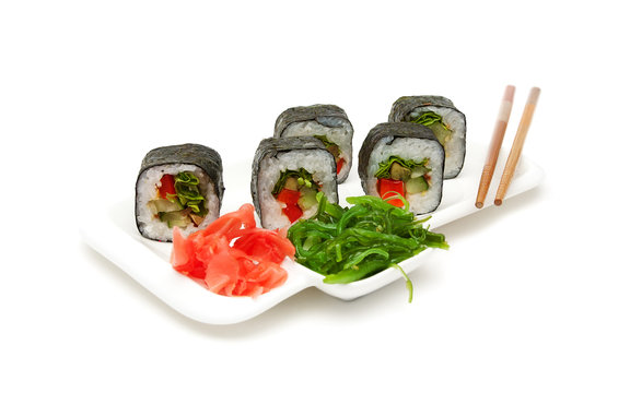 Japanese cuisine: rolls on a plate on a white background.