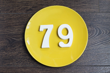 The number seventy-nine on the yellow plate.