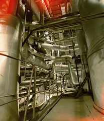 Equipment, cables and piping as found inside of a old industrial power plant