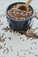 Bowl full of brown flaxseed or linseed. Cereals. Vitamins. Healthy food.
