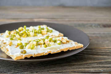 Vegetarian toast smeared with cream cheese, sprouts beans, gluten-free